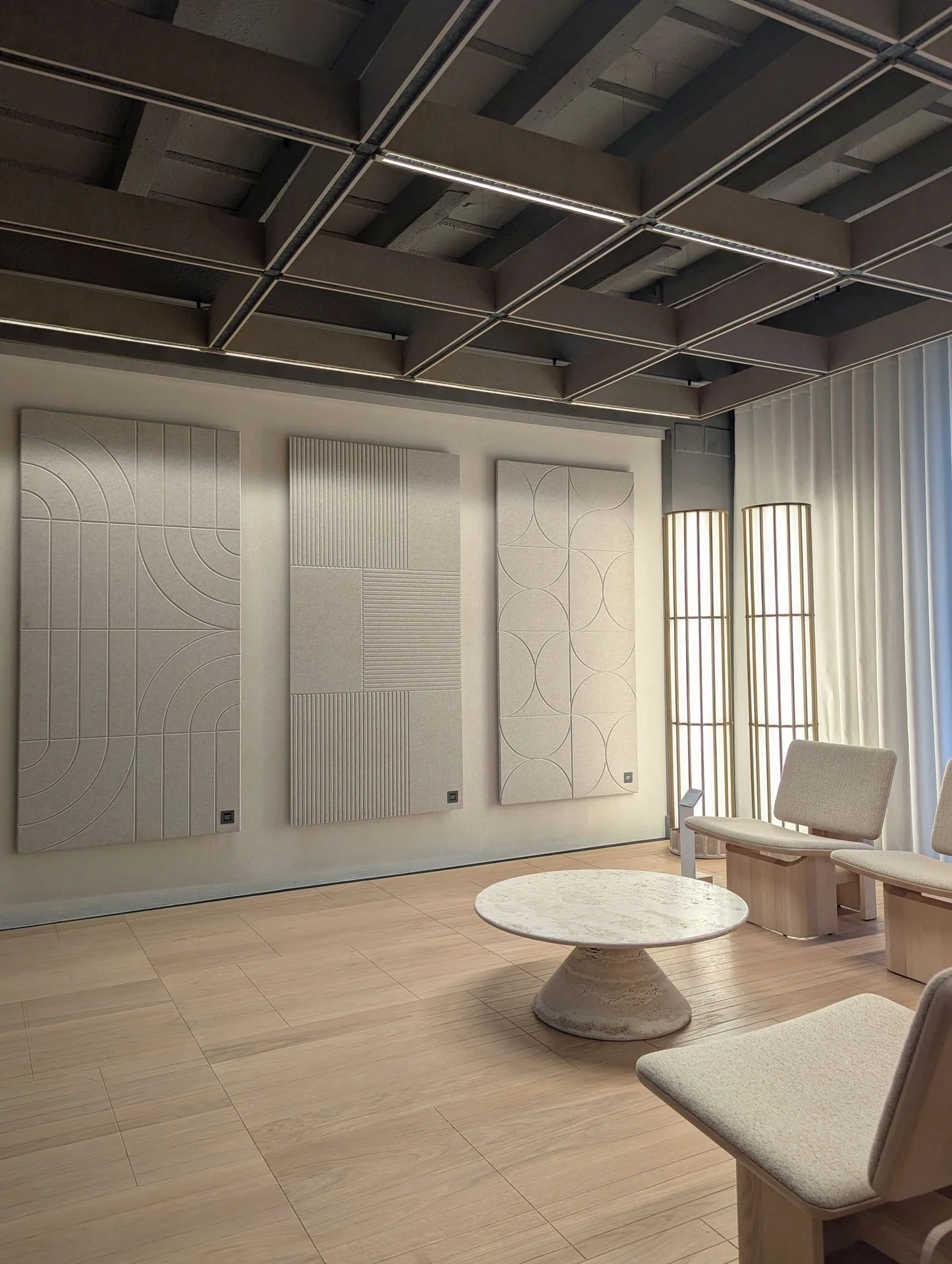 Three Motif Enlace panels on the wall of a room with a coffered ceiling