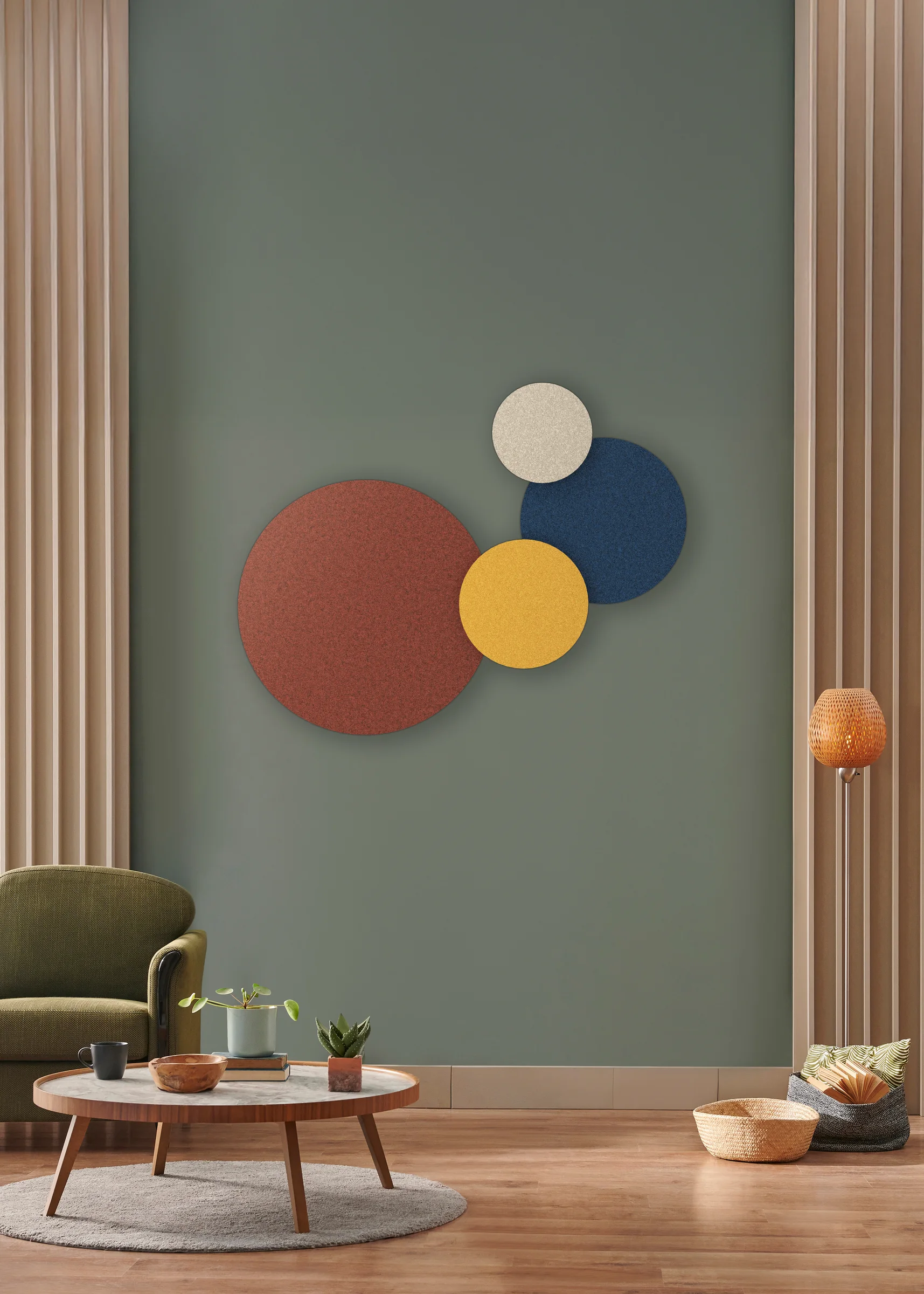 Waffle Acoustic Discs in terracotta, navy, yellow and cream on a green wall
