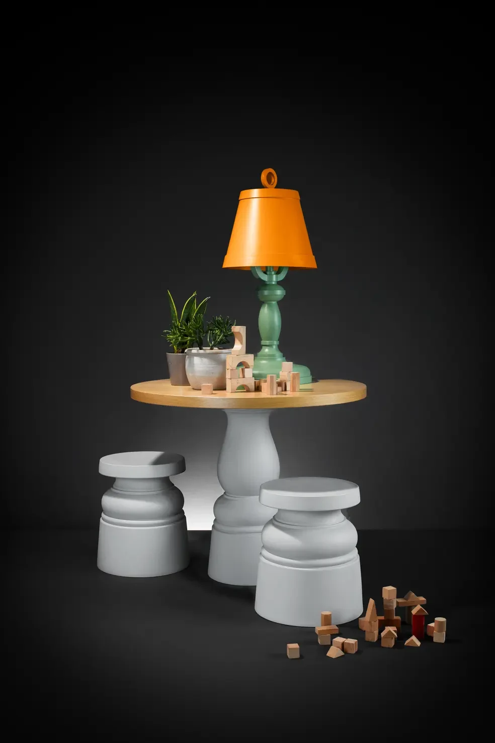 Two light grey Container Stools New Antiques beside a Container Table with a Paper table lamp
