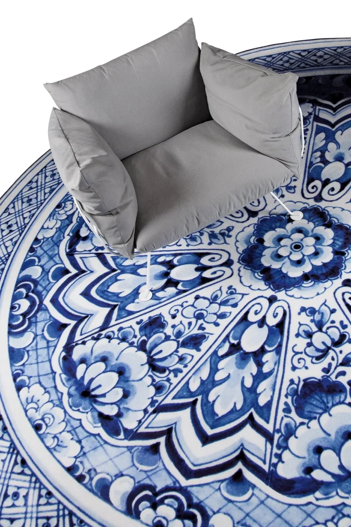 Delft Blue Plate rug by Marcel Wanders for Moooi Carpets with a grey armchair