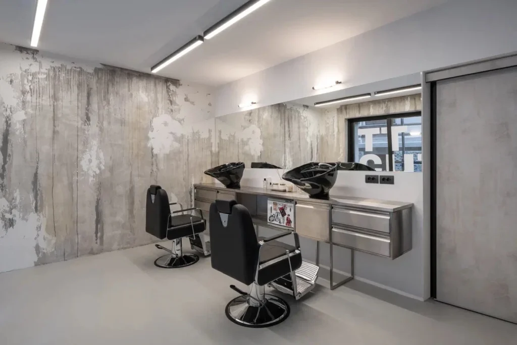 TT Cut, Belgrade: work stations with chairs and washbasins under linear ceiling lights