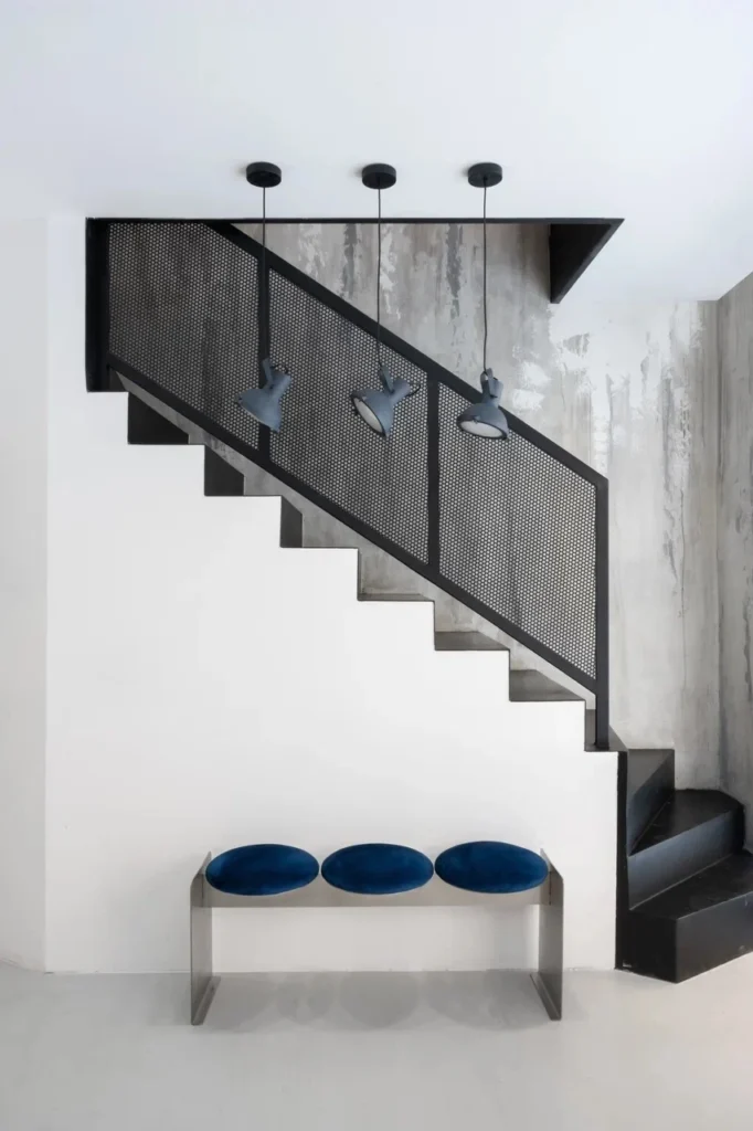 TT Cut, Belgrade: black steel staircase with three pendants above the bench