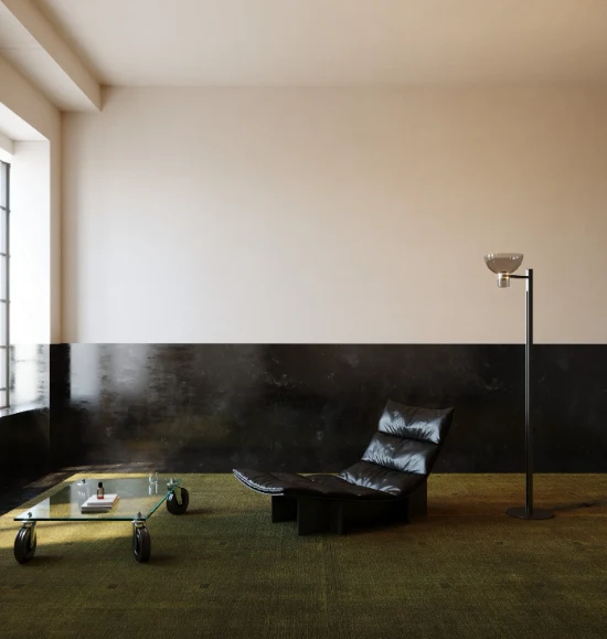 Flos Nocturne Floor Bowl beside a black leather lounger in a room with a dark green carpet