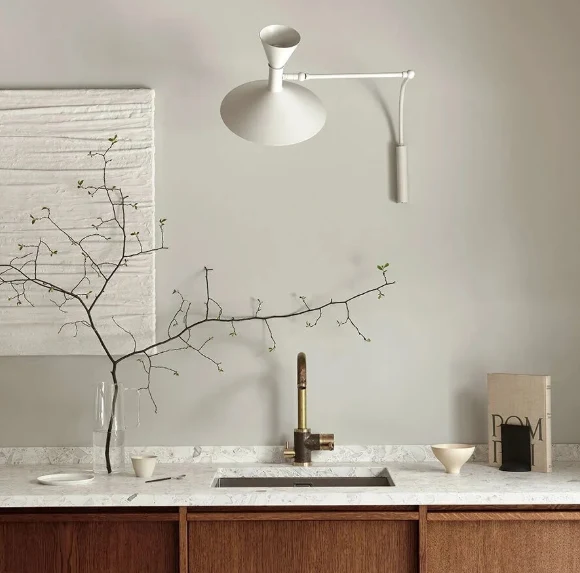 Nemo Lampe de Marseille Mini wall lamp in white above a stone kitchen counter